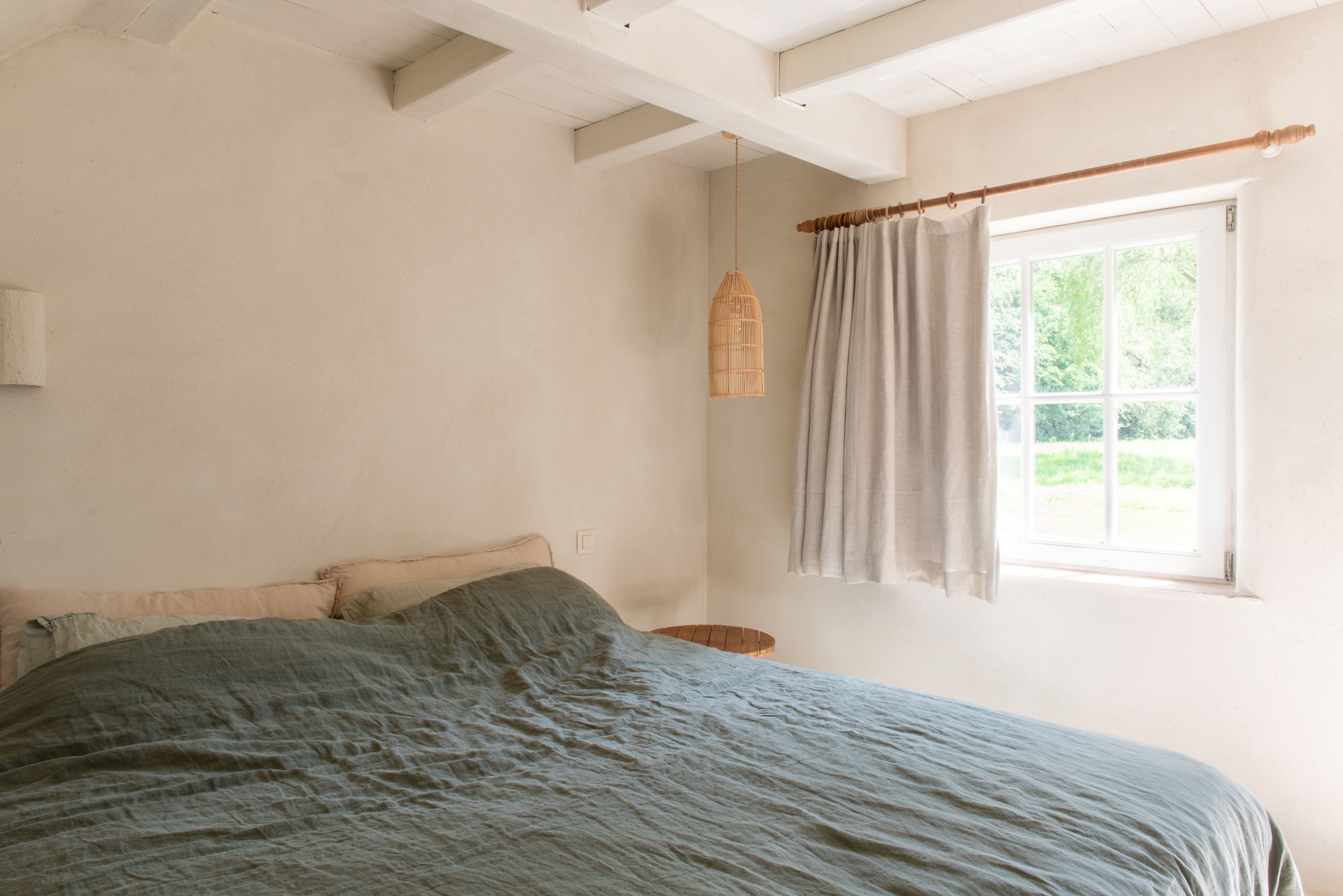 slaapkamer met bed in de gerestaureerde hoeve